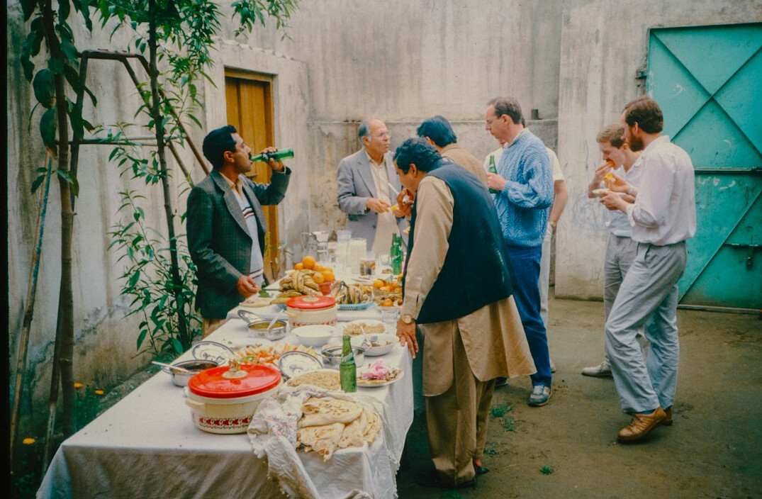 Production team discussing a live broadcast plan around a table