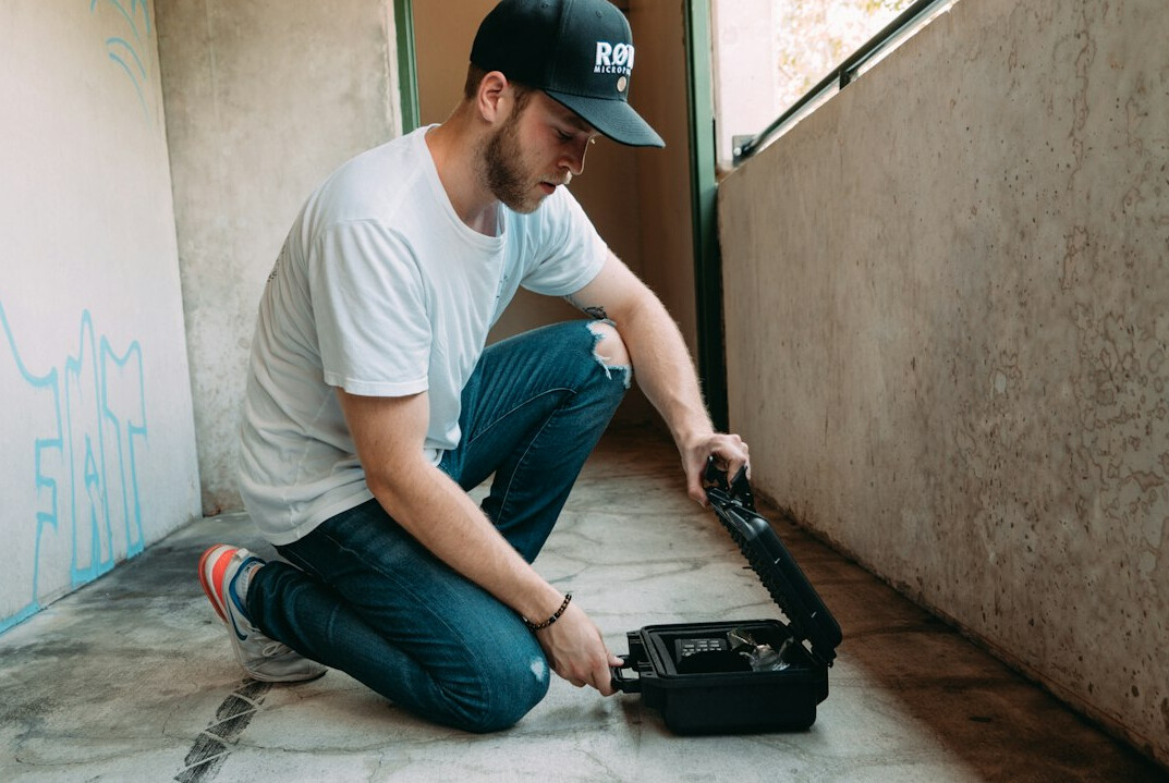 Technician working on a laptop connected to video equipment